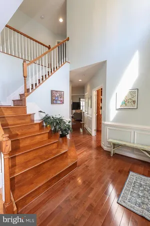 a kitchen with stainless steel appliances granite countertop wooden cabinets a stove a sink and a refrigerator