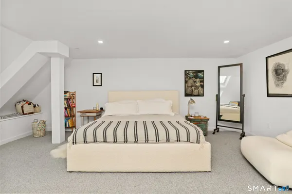 a bedroom with a bed and a couch