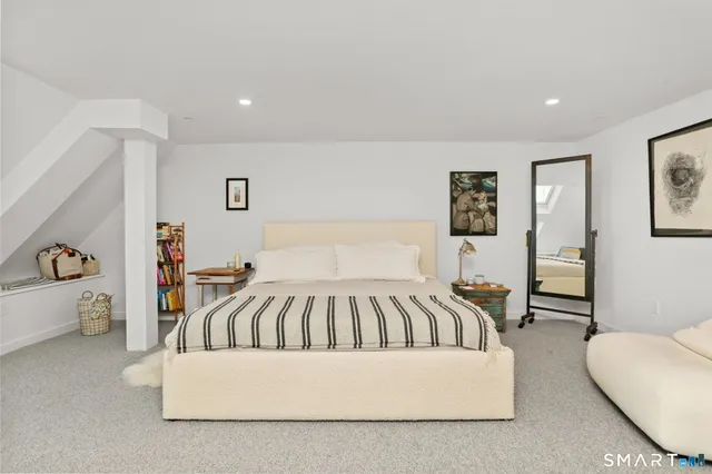 a spacious bedroom with a bed and a couch