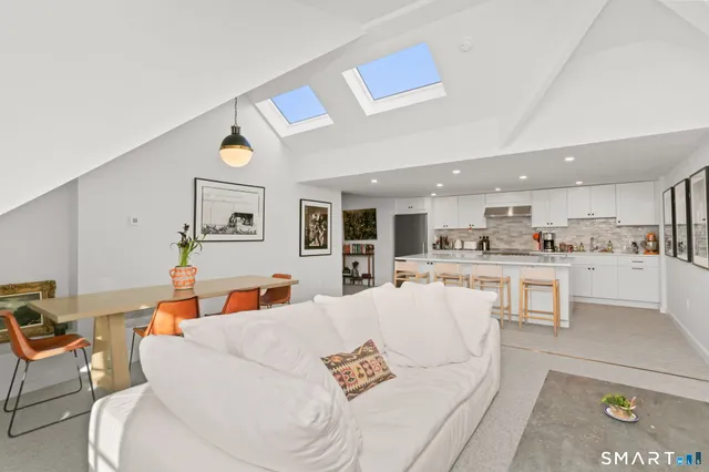a living room with furniture and kitchen view