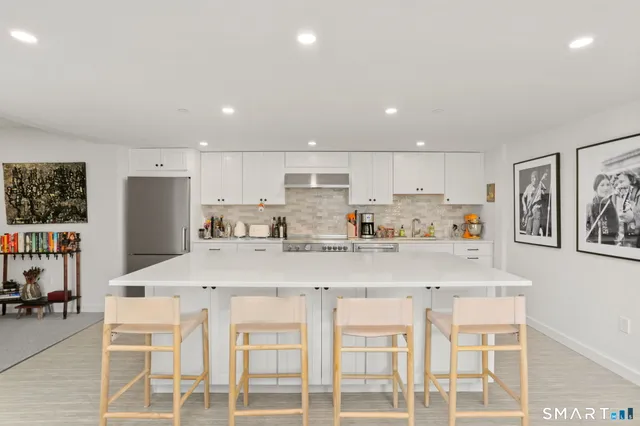 a living room with furniture a chandelier and a flat screen tv