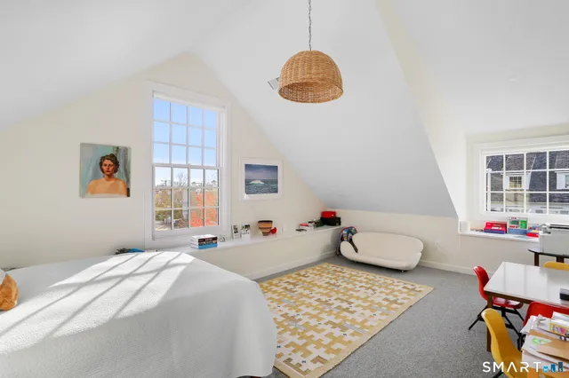 a spacious bedroom with bed and a couch