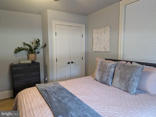 a bedroom with a bed and a potted plant