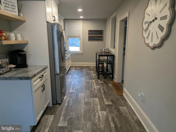 a kitchen with a sink appliances and cabinets