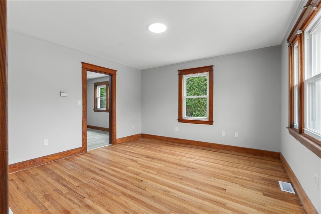 19 Brandon Road Dudley, MA 01571 - Photo 31 of 42 a view of an empty room with wooden floor and a window