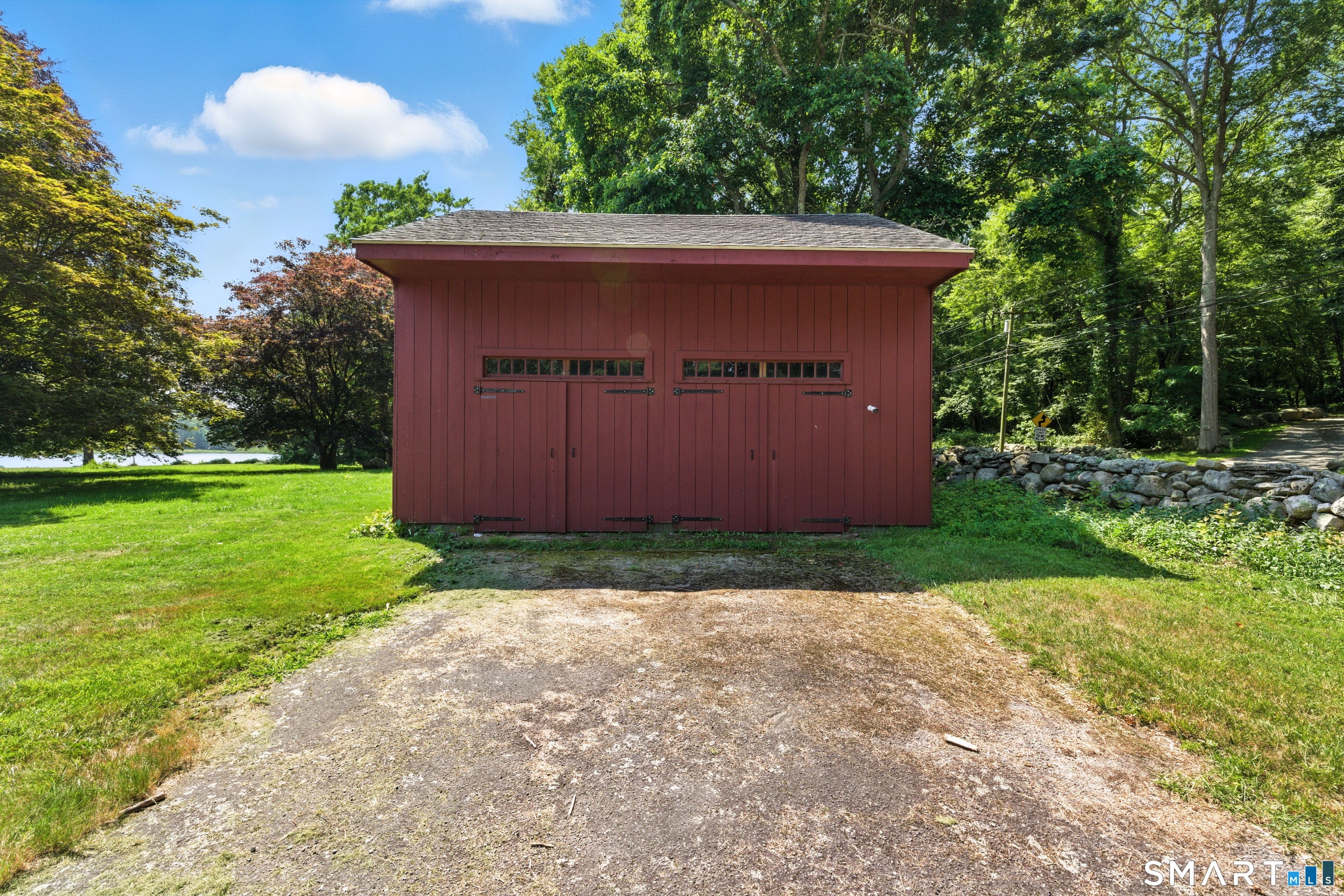 88 Cove Road Stonington, CT 06378 - Photo 12 of 27 a backyard of a house with lots of green space