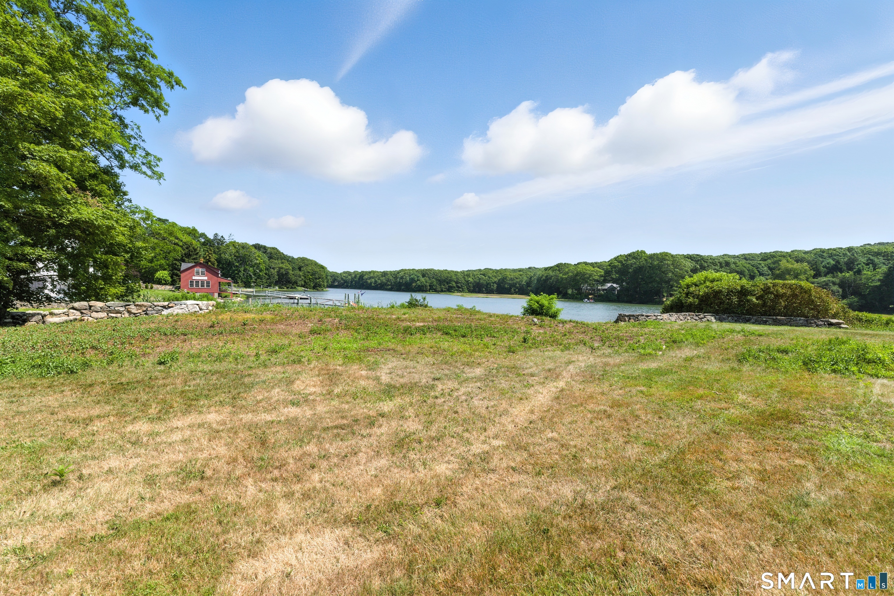 88 Cove Road Stonington, CT 06378 - Photo 20 of 27 a view of a lake and a yard