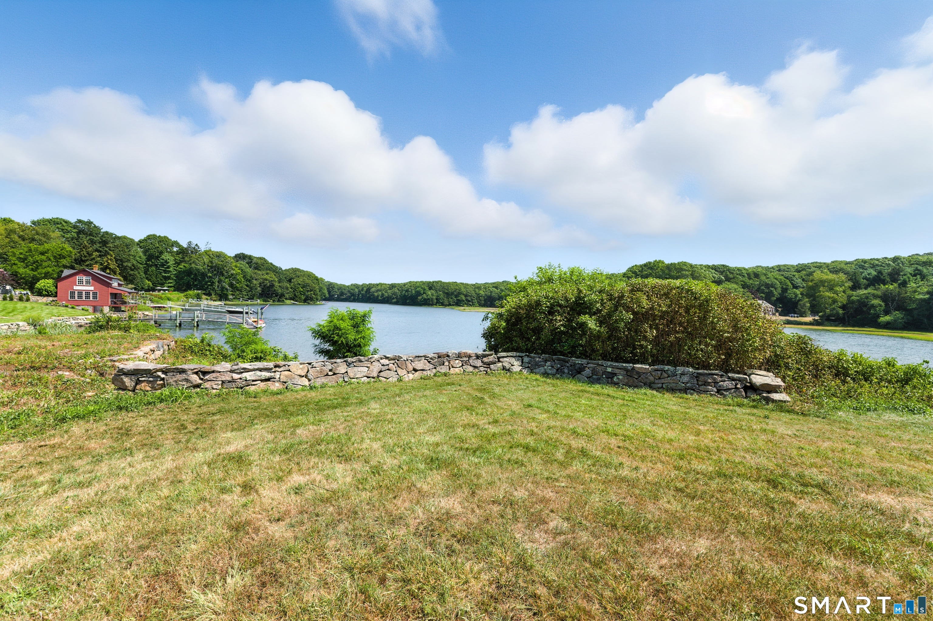 88 Cove Road Stonington, CT 06378 - Photo 23 of 27 a view of a lake with houses in the back