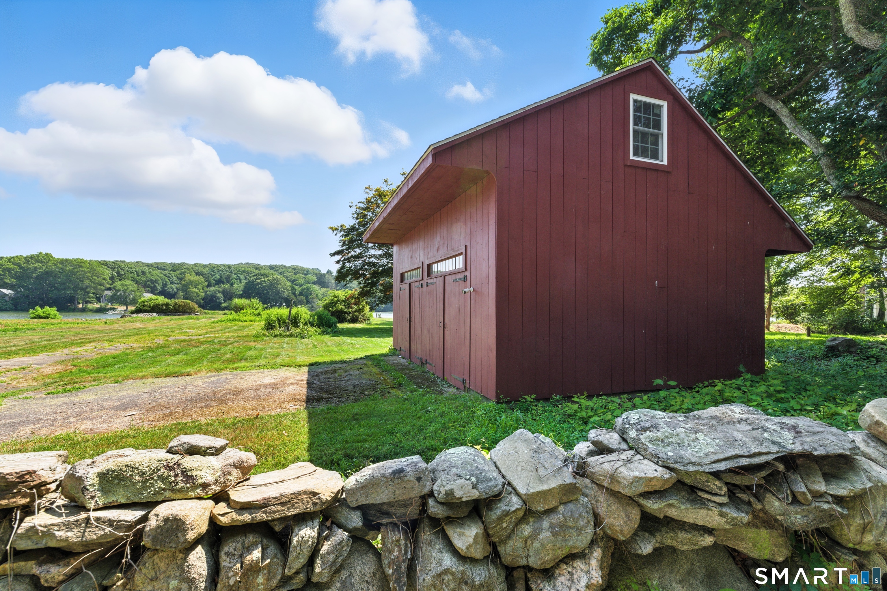 88 Cove Road Stonington, CT 06378 - Photo 4 of 27 a view of backyard of house with seating space