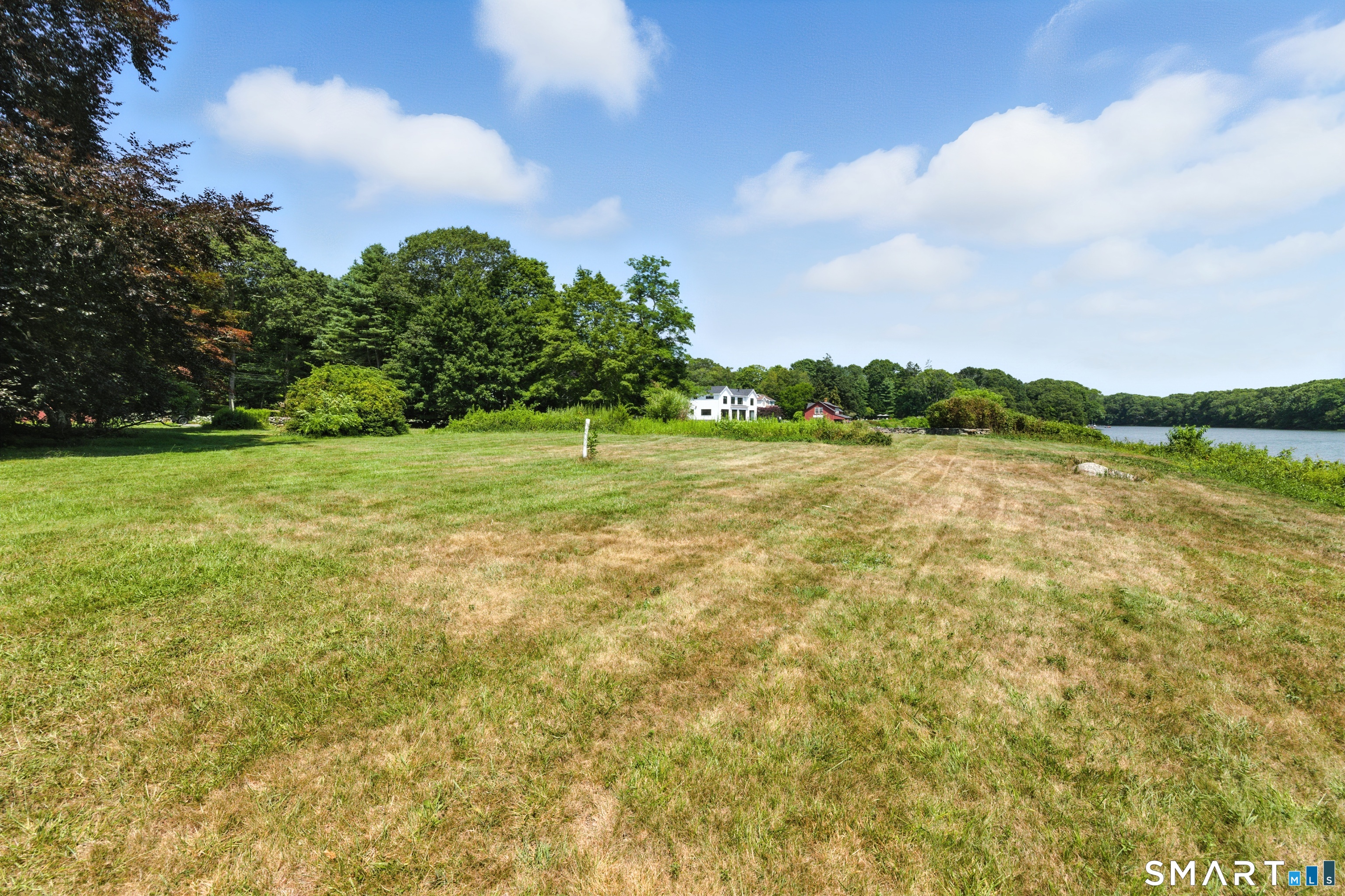 88 Cove Road Stonington, CT 06378 - Photo 5 of 27 a view of a lake with houses in the back