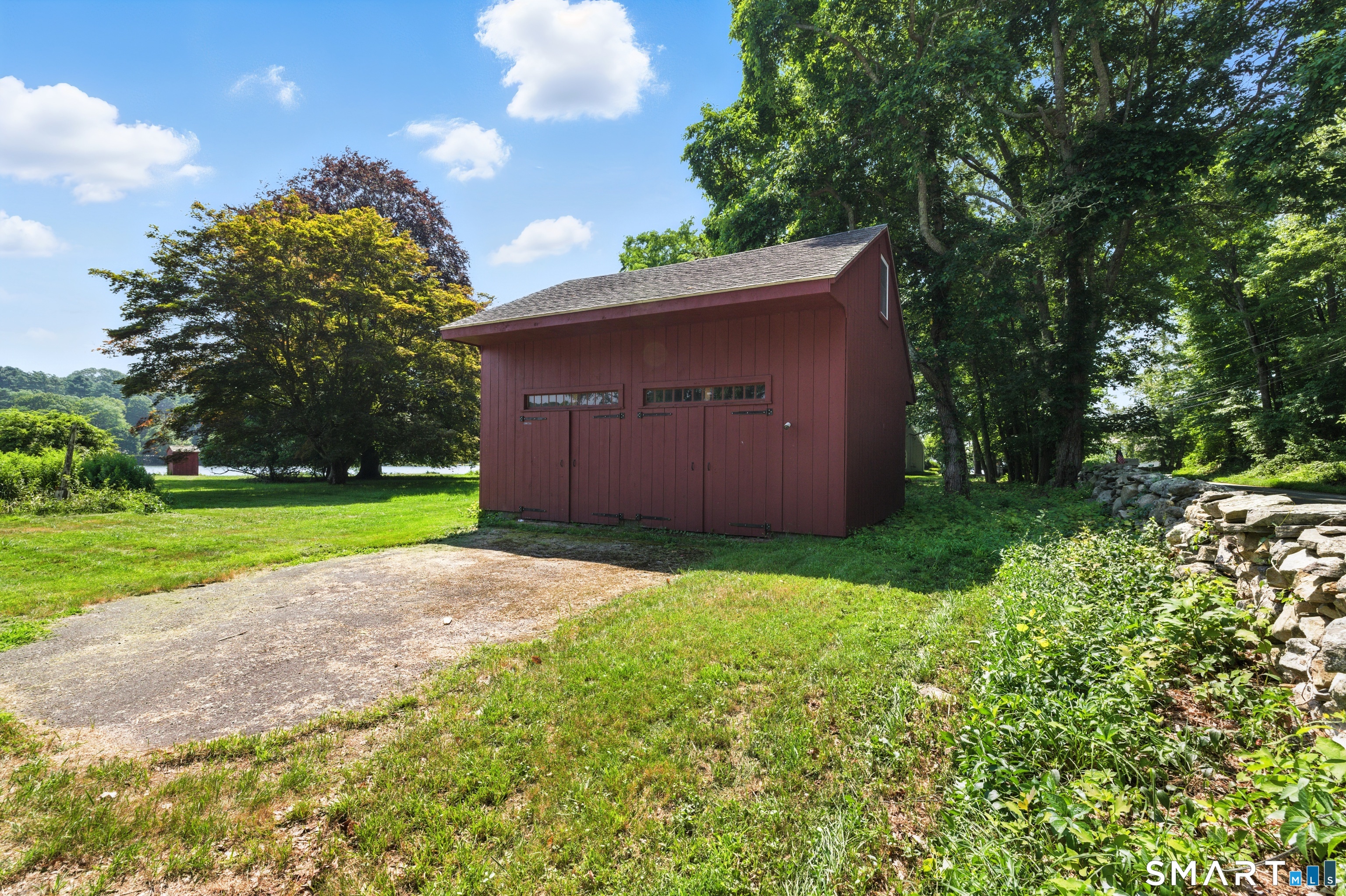 88 Cove Road Stonington, CT 06378 - Photo 10 of 27 a view of a backyard with large trees and plants