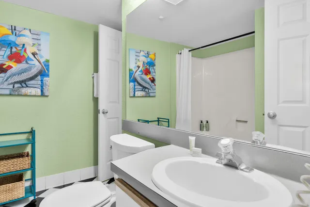 a bathroom with a sink a mirror and a toilet