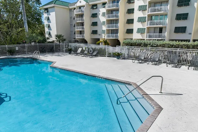 a view of swimming pool with outdoor seating and plants