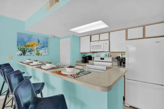 a kitchen with a dining table and chairs