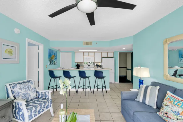 a view of a livingroom with furniture and a potted plant