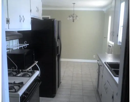 a kitchen with a sink appliances and cabinets