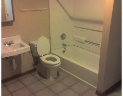 a bathroom with a toilet sink and shower