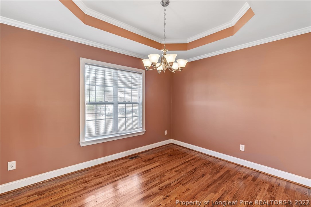 31 Reece Drive Sanford, NC 27332 - Photo 11 of 36 a view of empty room with wooden floor and fan