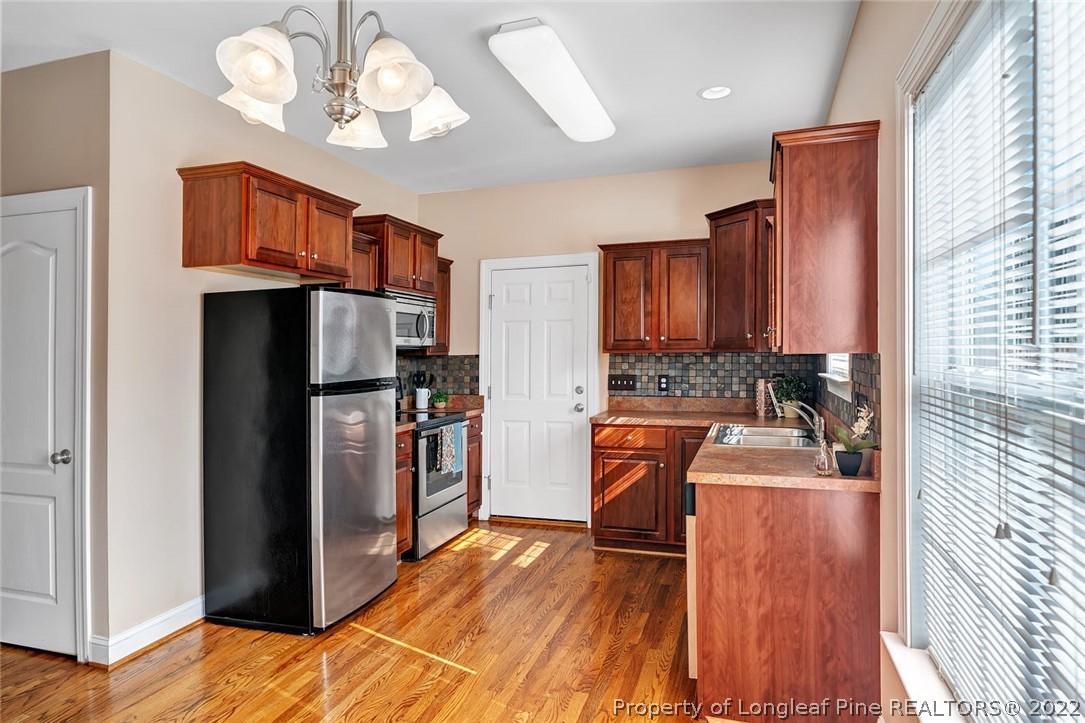 31 Reece Drive Sanford, NC 27332 - Photo 13 of 36 a kitchen with stainless steel appliances granite countertop a refrigerator a stove top oven a sink and dishwasher