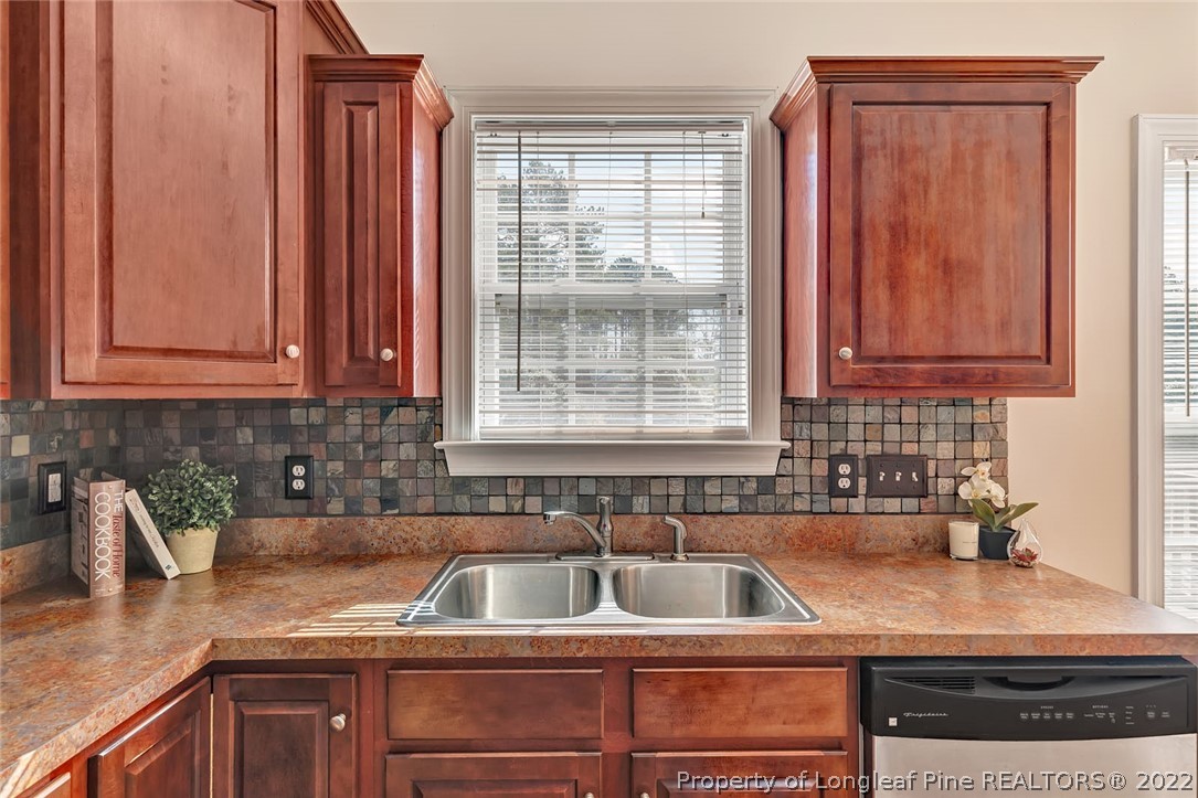 31 Reece Drive Sanford, NC 27332 - Photo 15 of 36 a kitchen with granite countertop a sink a stove and cabinets