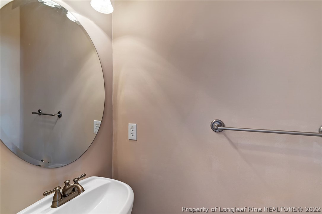 31 Reece Drive Sanford, NC 27332 - Photo 17 of 36 a bathroom with a sink mirror and toilet