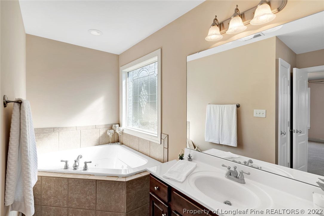 31 Reece Drive Sanford, NC 27332 - Photo 30 of 36 a bathroom with a sink and a mirror