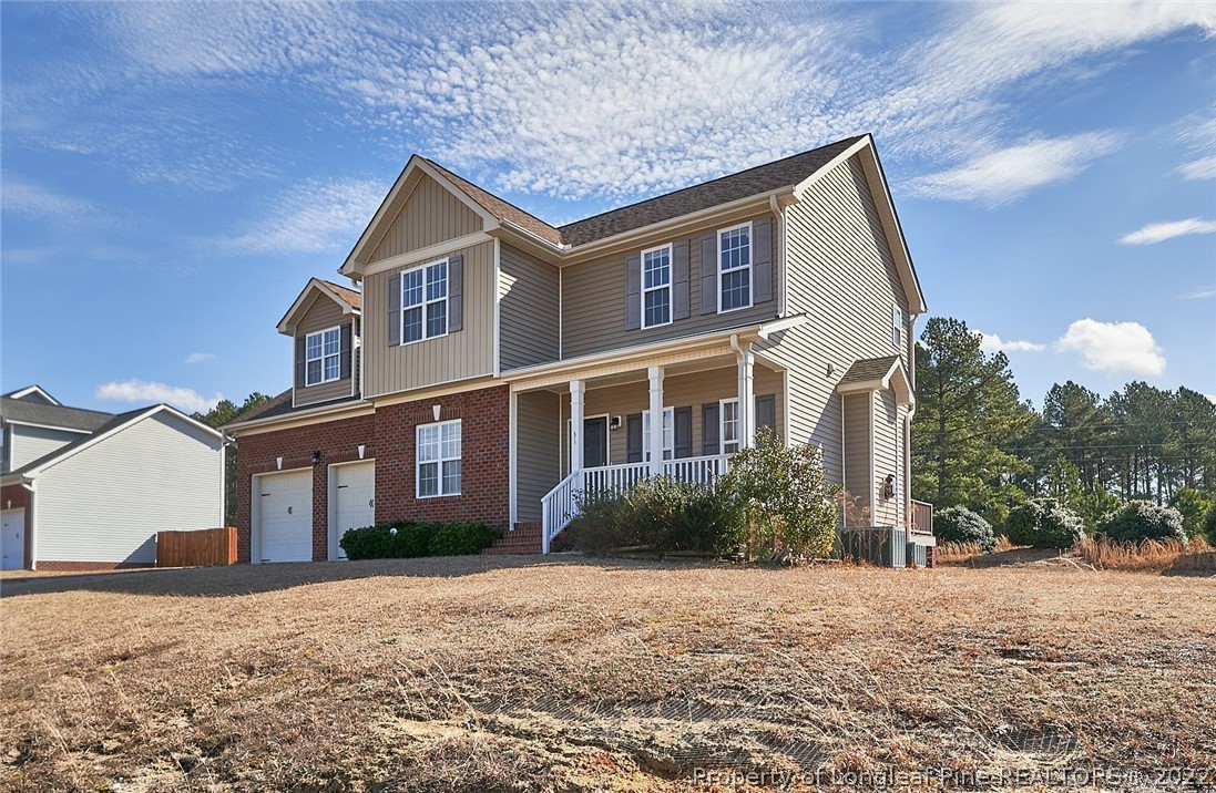 31 Reece Drive Sanford, NC 27332 - Photo 4 of 36 a front view of a house with a yard and garage