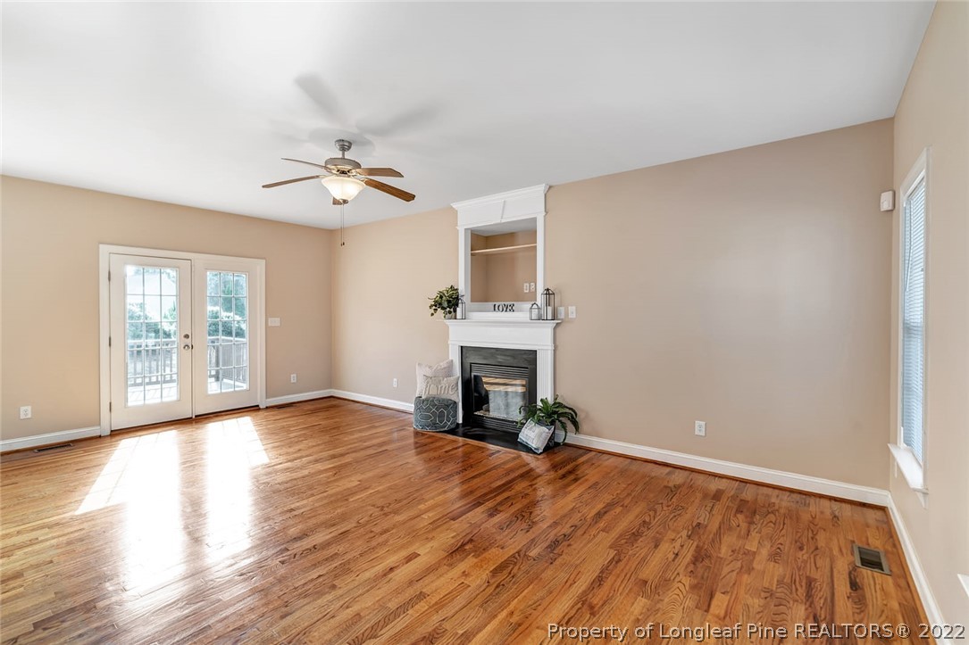 31 Reece Drive Sanford, NC 27332 - Photo 5 of 36 a view of empty room with fireplace and wooden floor