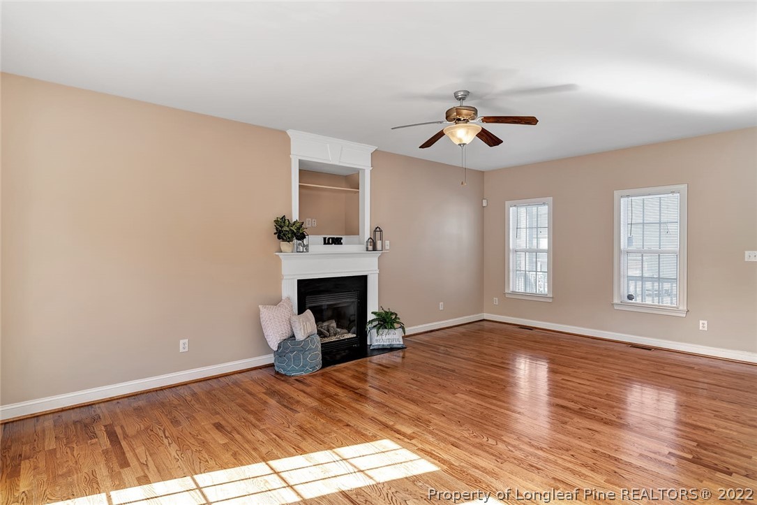 31 Reece Drive Sanford, NC 27332 - Photo 7 of 36 a view of empty room with fireplace and wooden floor