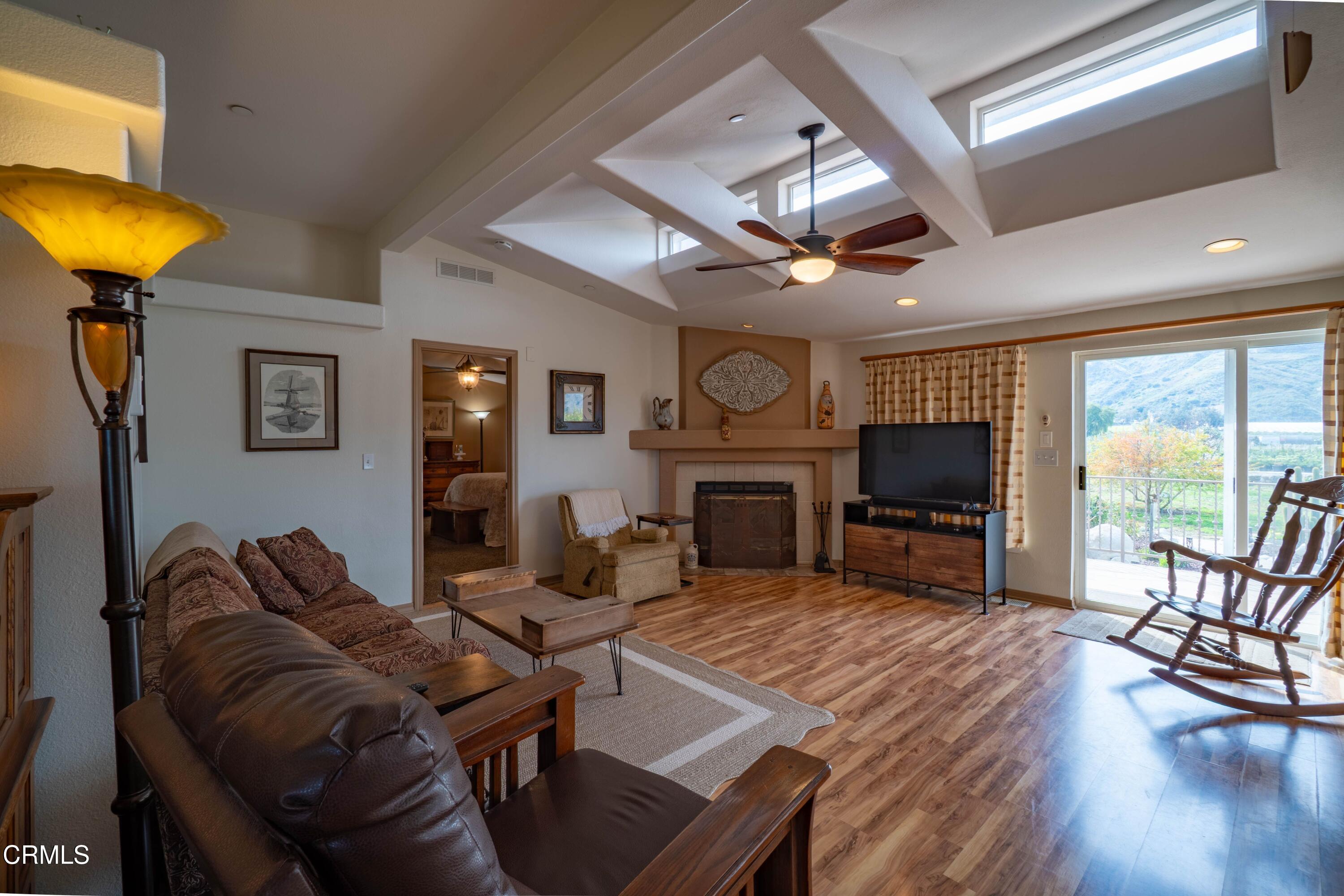 3760 Howe Road Fillmore, CA 93015 - Photo 14 of 32 a living room with furniture a fireplace and a flat screen tv