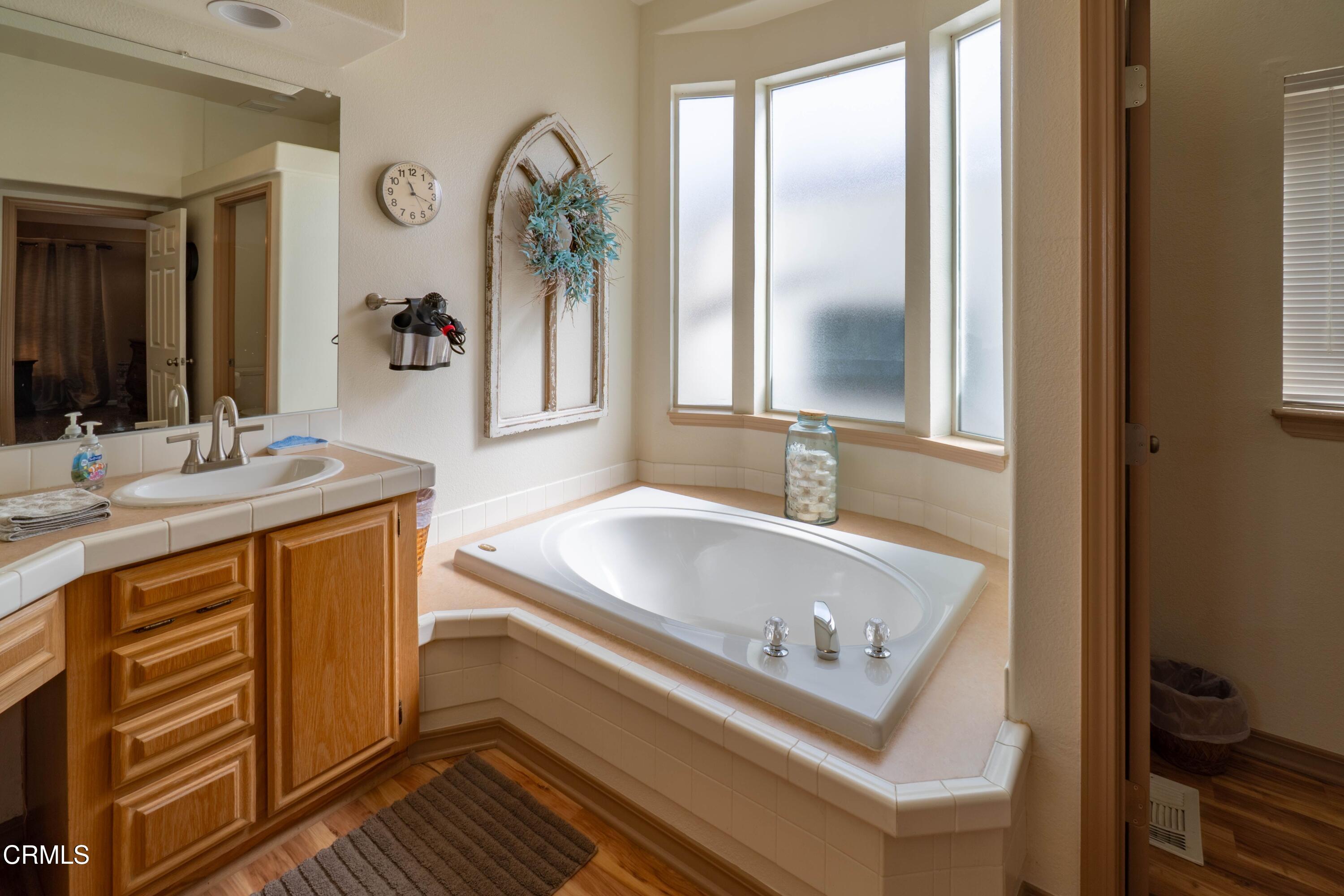 3760 Howe Road Fillmore, CA 93015 - Photo 17 of 32 a bathroom with a tub sink and mirror