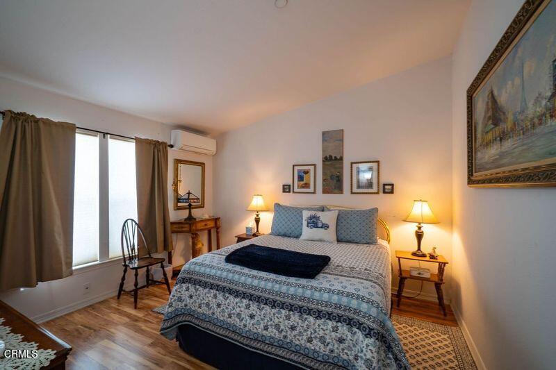 3760 Howe Road Fillmore, CA 93015 - Photo 19 of 32 a bedroom with a bed wooden floor and lamp
