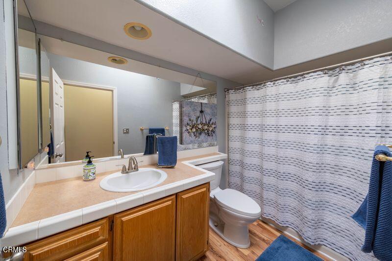 3760 Howe Road Fillmore, CA 93015 - Photo 21 of 32 a bathroom with a granite countertop toilet sink and mirror