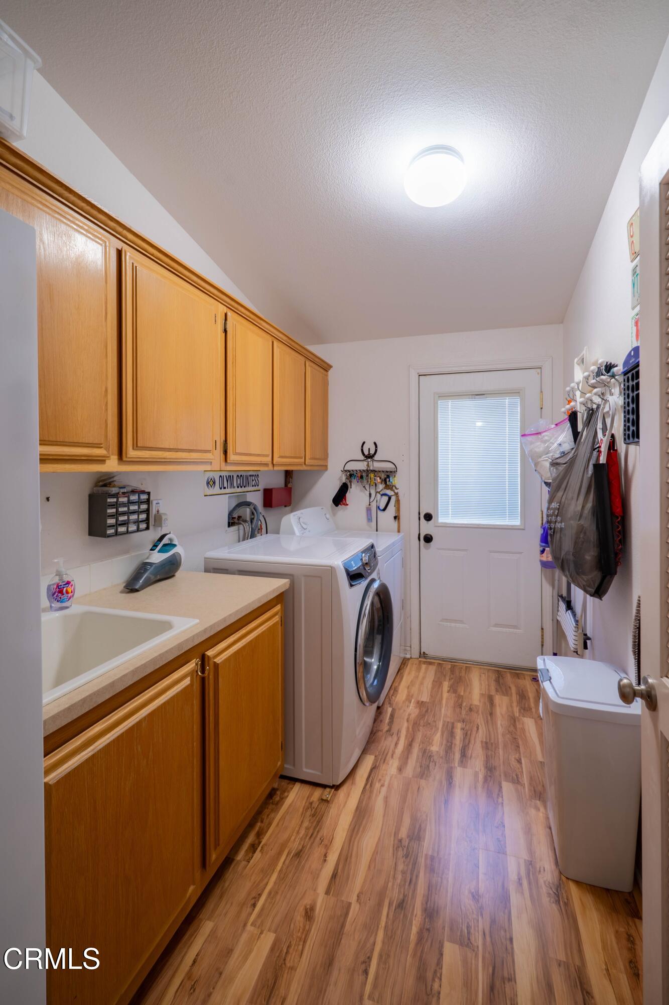 3760 Howe Road Fillmore, CA 93015 - Photo 22 of 32 a utility room with dryer washer and a wooden floors