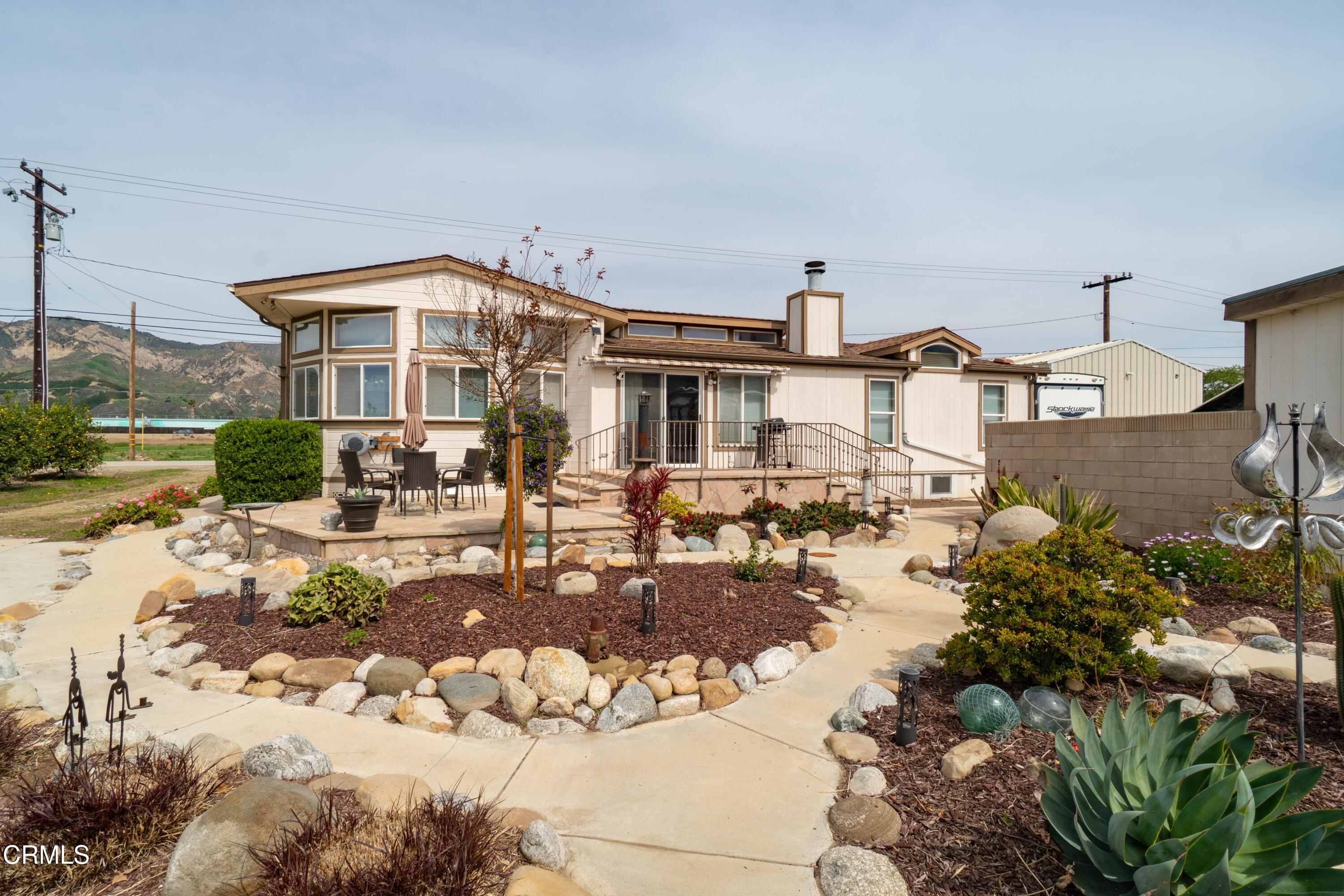 3760 Howe Road Fillmore, CA 93015 - Photo 26 of 32 a view of a house with backyard outdoor seating area and fire pit