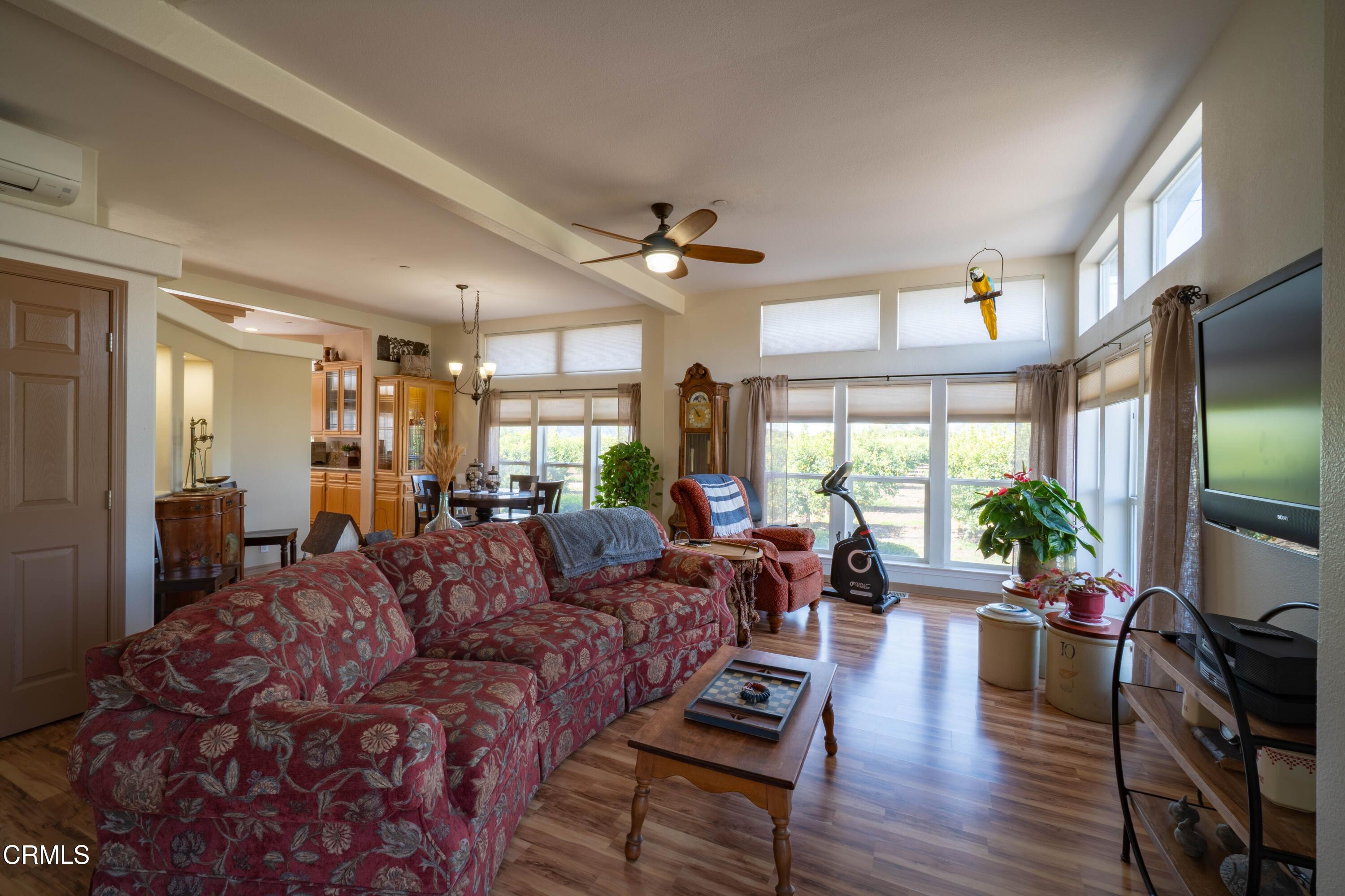 3760 Howe Road Fillmore, CA 93015 - Photo 8 of 32 a living room with furniture a flat screen tv and a large window