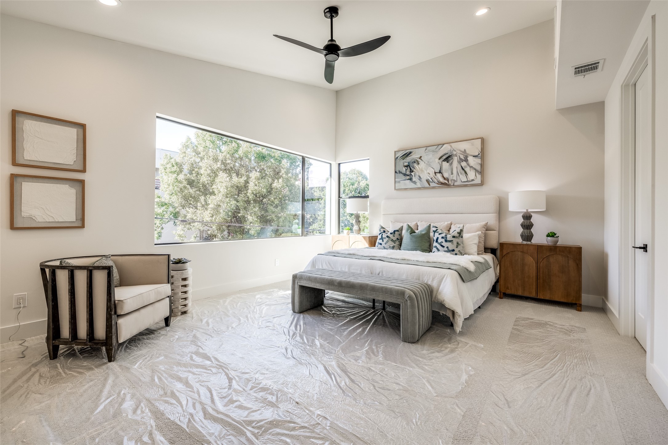 2410 Quenby Street Houston, TX 77005 - Photo 22 of 37 a spacious bedroom with a bed and a couch