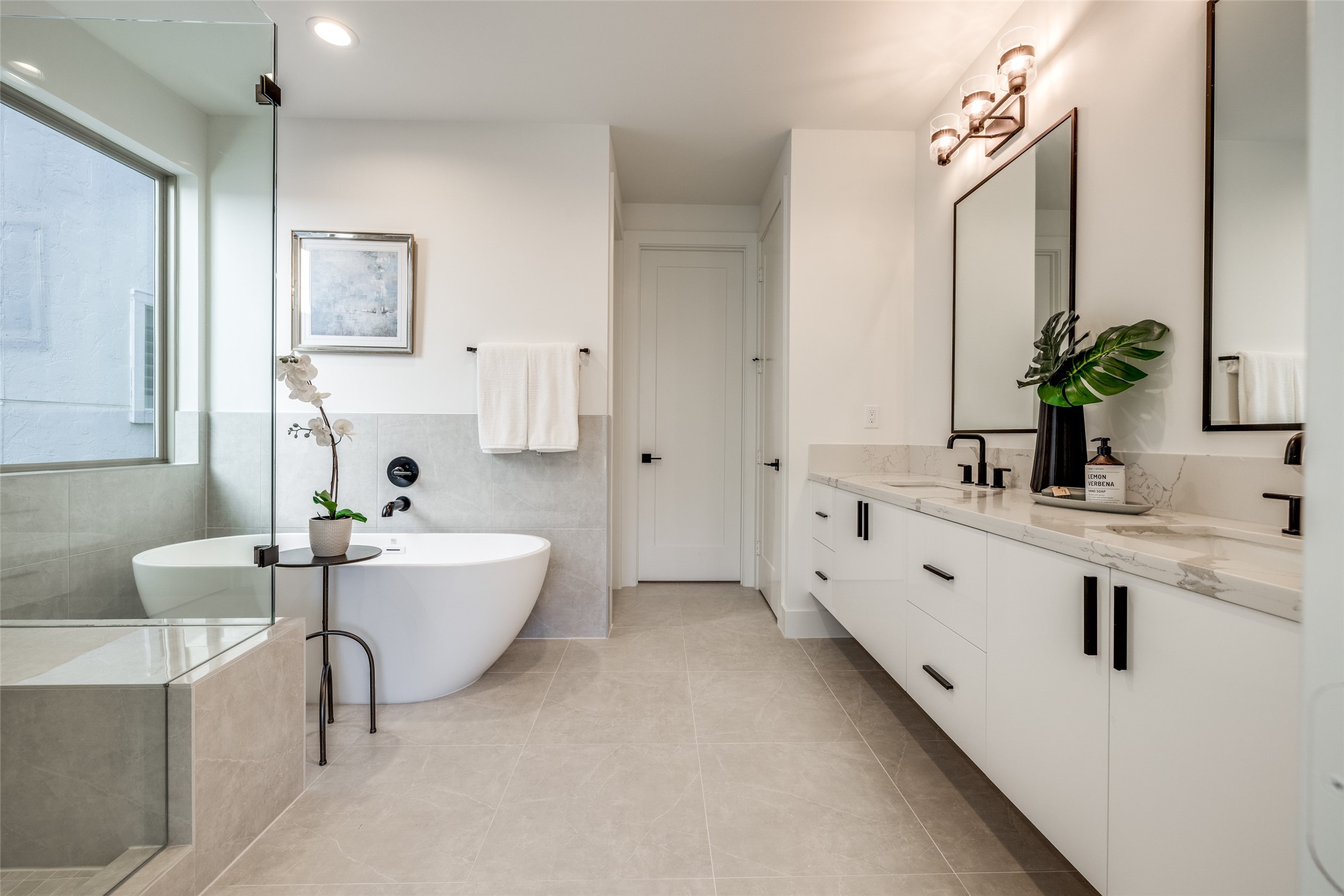 2410 Quenby Street Houston, TX 77005 - Photo 24 of 42 a spacious en suite bathroom with a double vanity sink tub and mirror