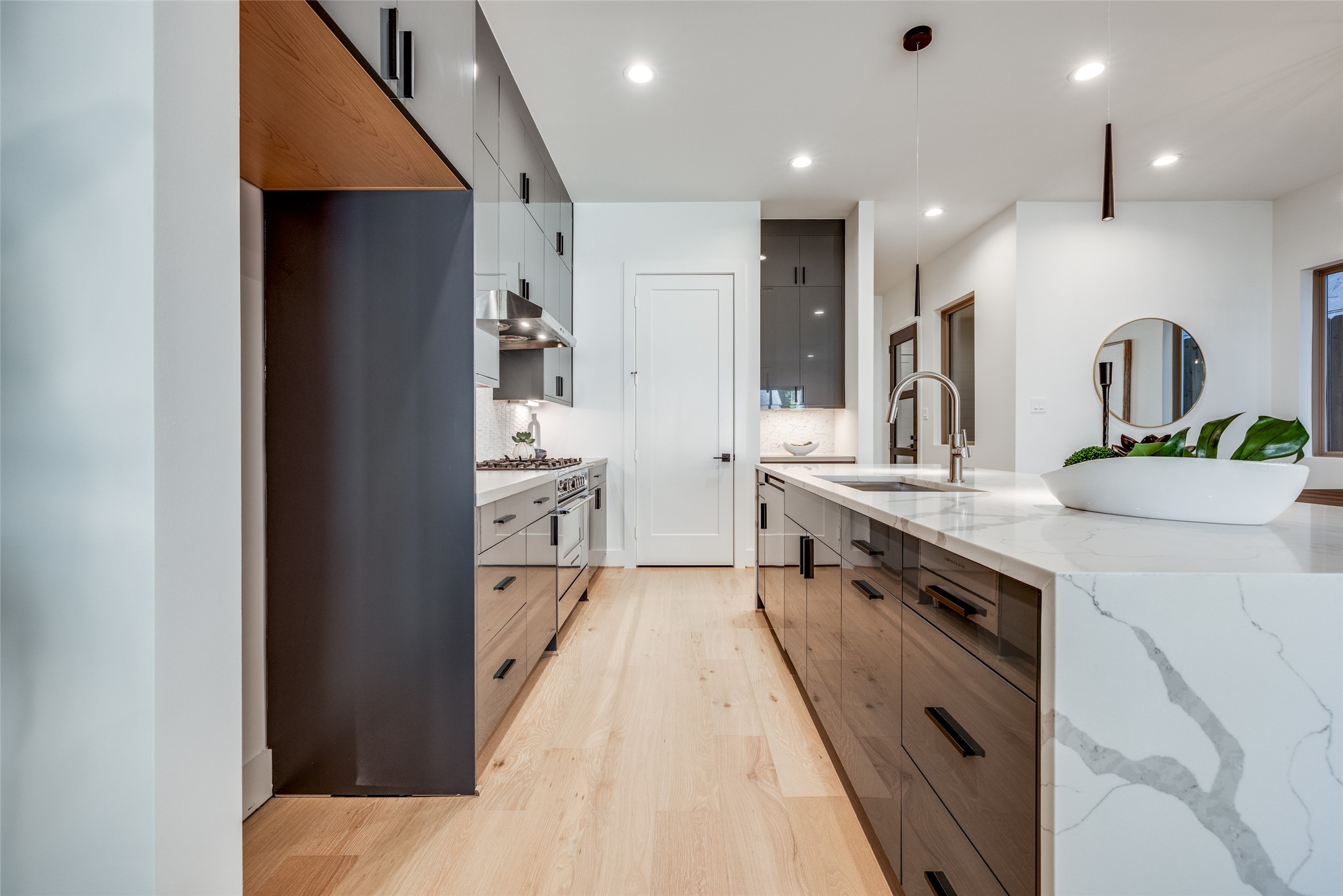 2410 Quenby Street Houston, TX 77005 - Photo 9 of 37 a large kitchen with stainless steel appliances kitchen island granite countertop a refrigerator and a sink