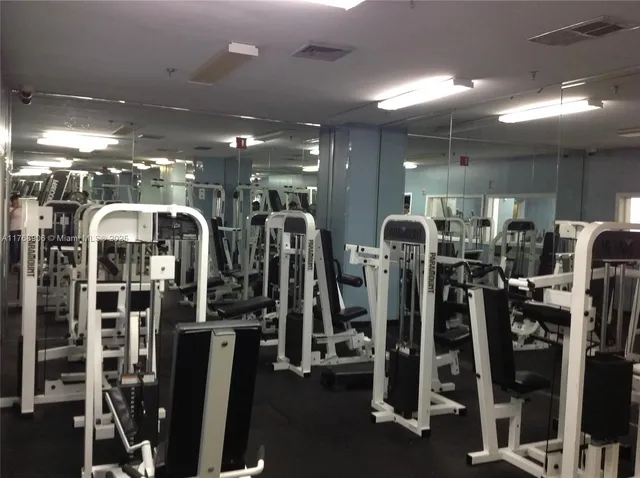 a view of a building with a yard next to a road