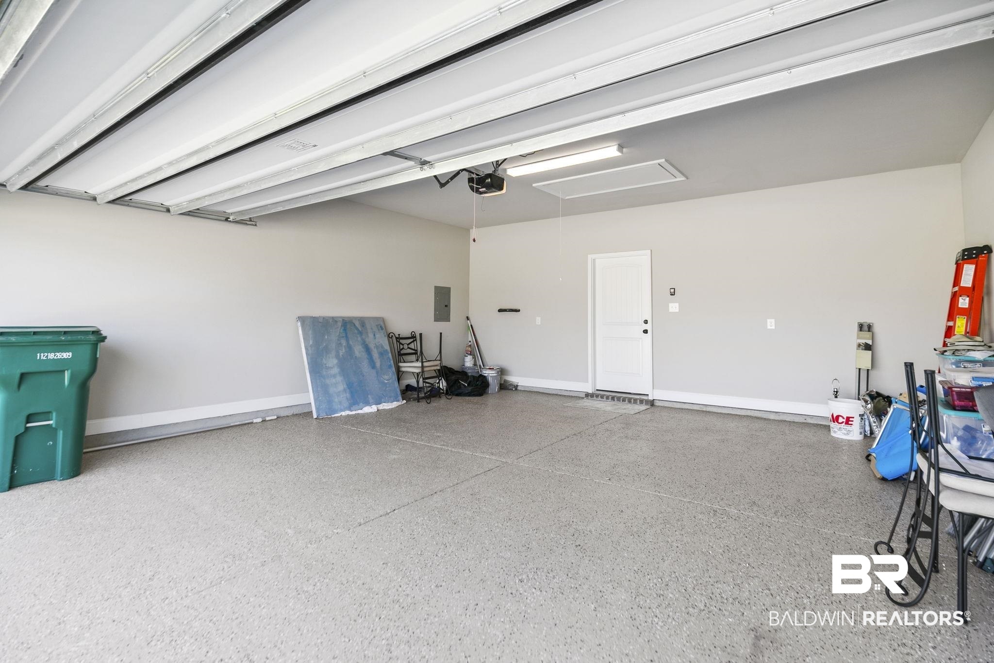 10140 Chipper Lane Foley, AL 36535 - Photo 41 of 72 Garage featuring a garage door opener and electric panel
