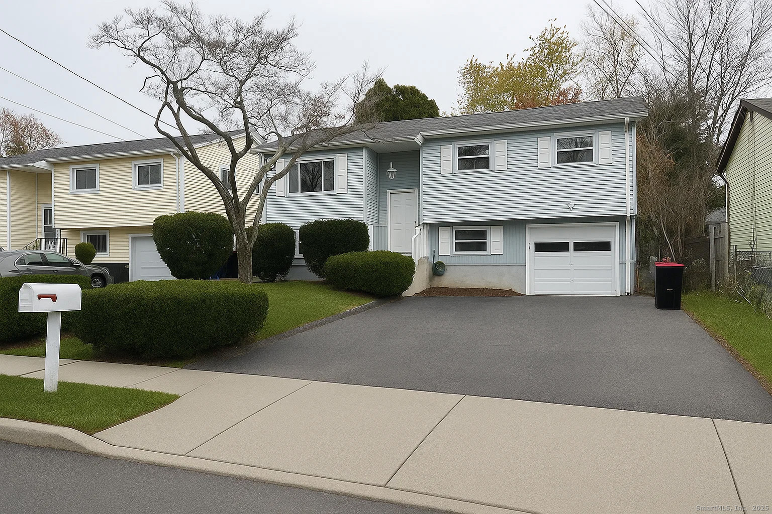 a view of a house with a yard and a garage