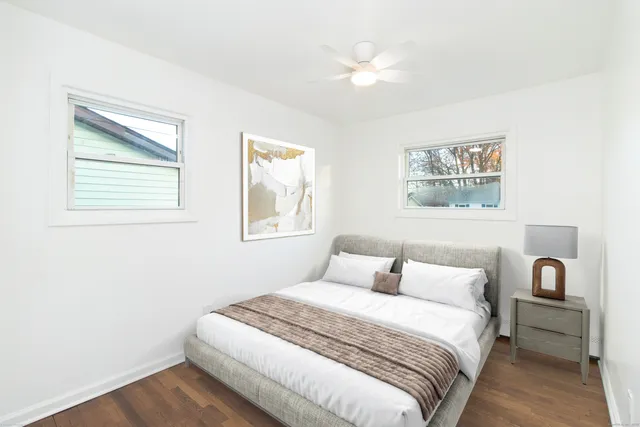 a bedroom with a bed and a painting on the wall