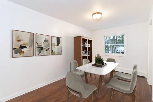 a dining room with furniture and window