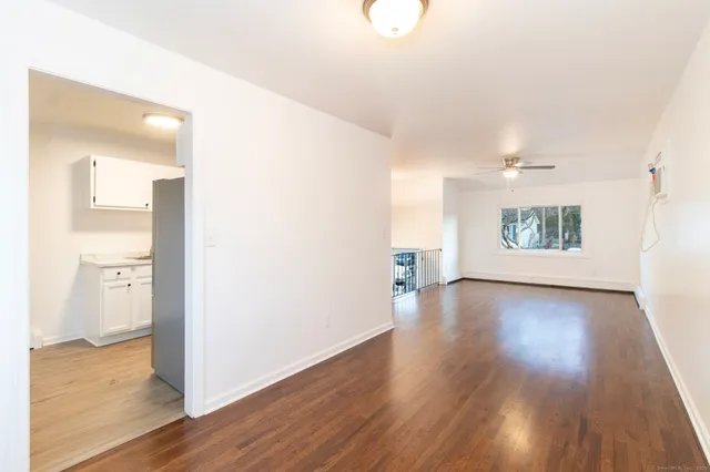 a view of an empty room and wooden floor