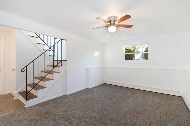 a view of entryway and hall with a ceiling fan
