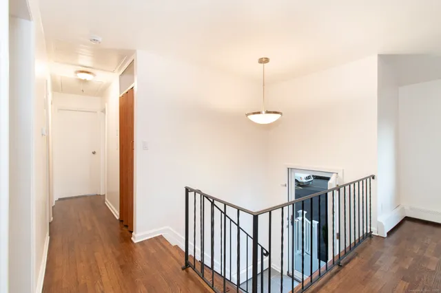 a view of a hallway with wooden floor