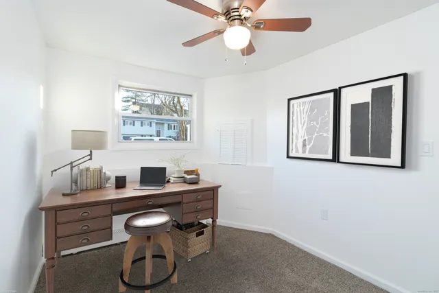 a room with a table chairs and a window