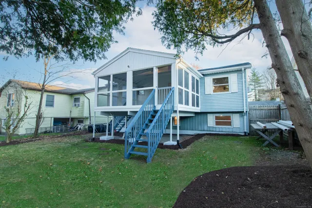 a view of a house with a yard porch and sitting area