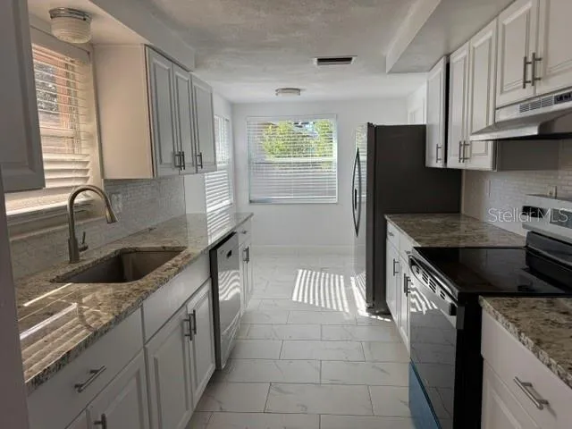 a kitchen with a sink and cabinets
